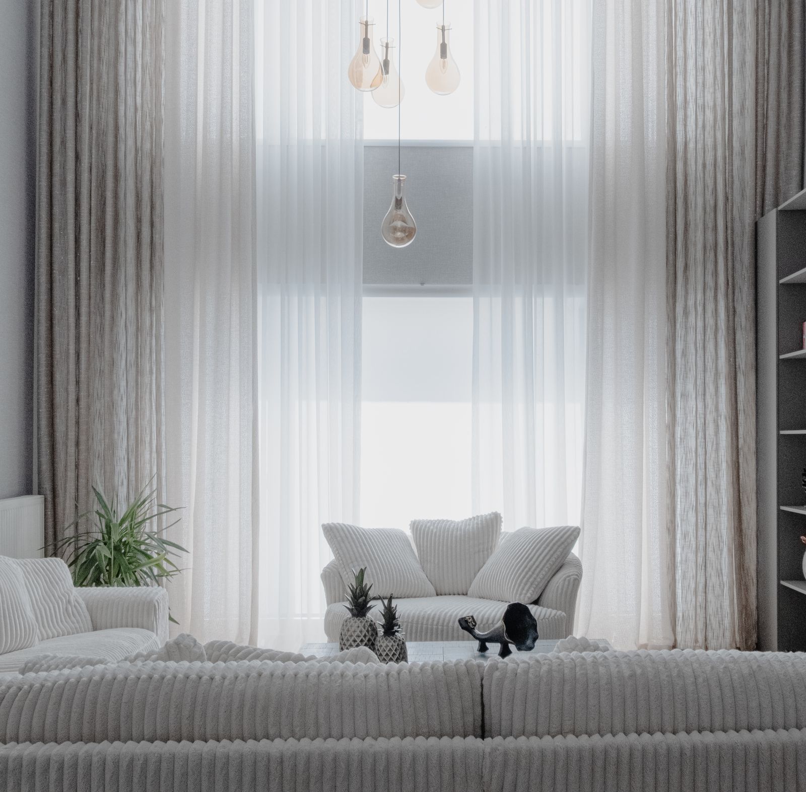 Illustrative stock home with layered sheer curtains and soft furnishings